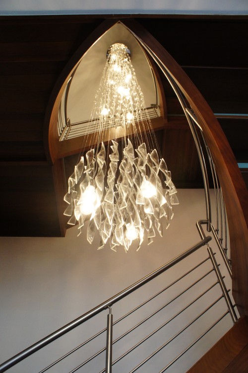 I designed this custom stairwell light to suspend through three stories!  