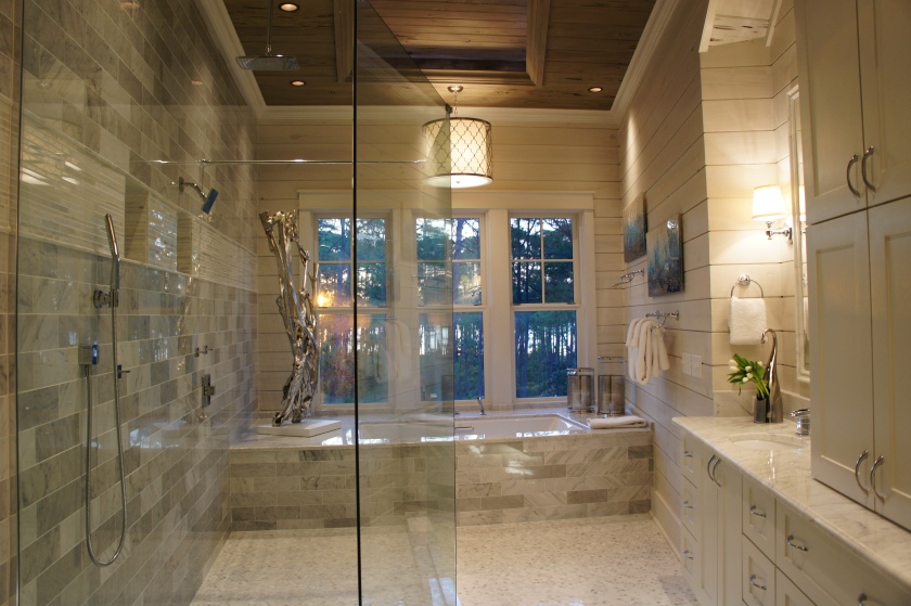 This is a stunning bathroom, with its marble floors and walls, the large open windows and recessed ceiling detail.