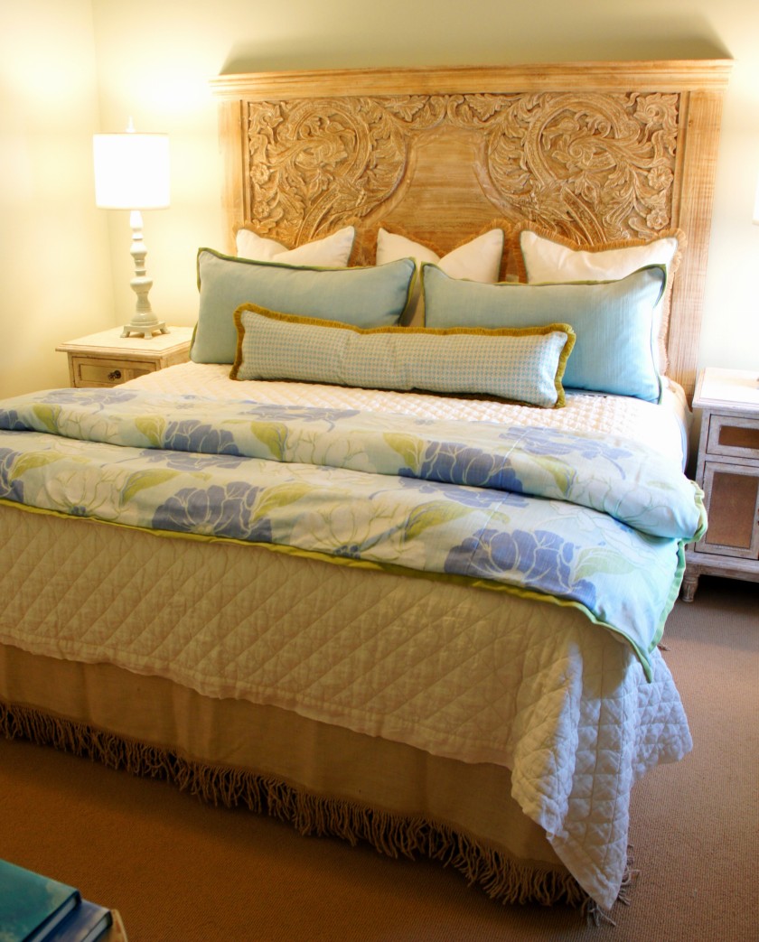 In this room, I used this fabulous carved wood headboard that I found at Nest Interiors, and paired it with some jute fringe euros, and some custom pillows.  I absolutely love the aqua, green and periwinkle color combination in this foot blanket!